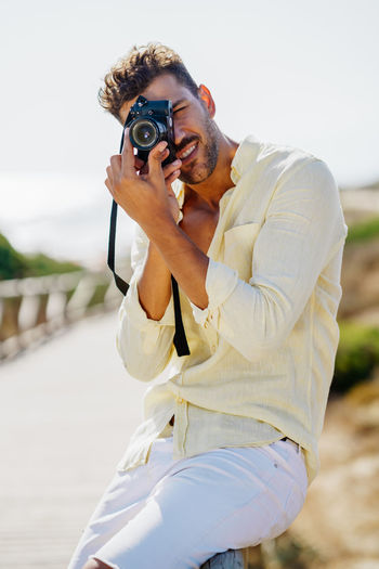 Man photographing with camera outdoors