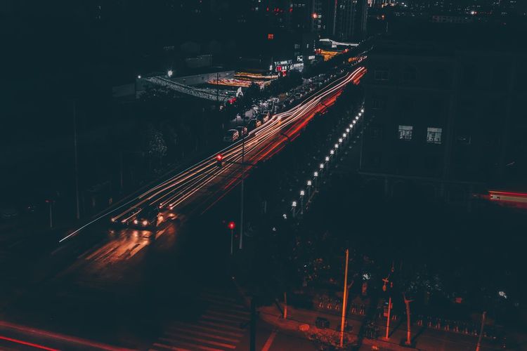 High angle view of light trails on road at night