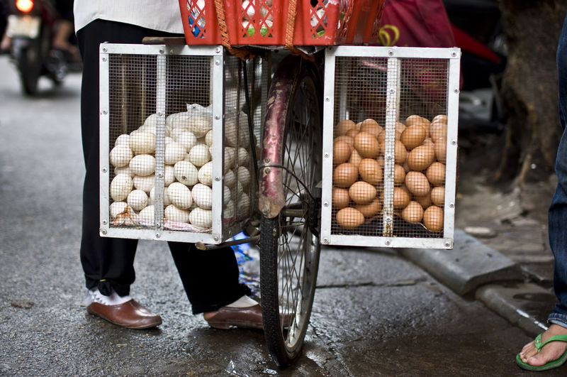 Person selling eggs on bicycle at street