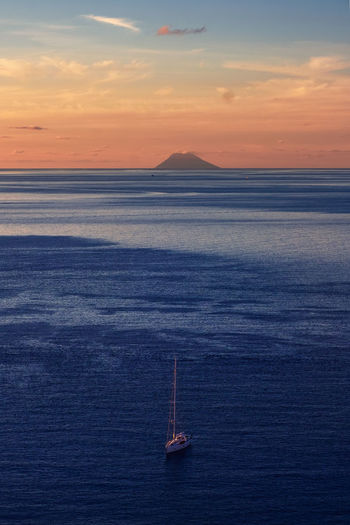 Scenic view of stromboli against sky during sunset
