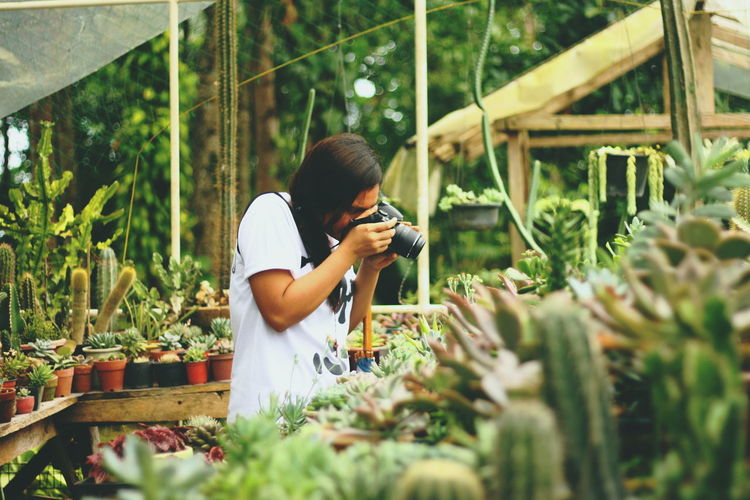 Man photographing in greenhouse