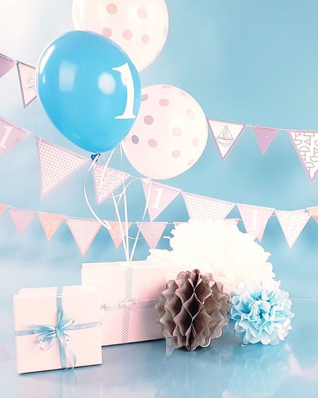 Close-up of balloons on table against blue background