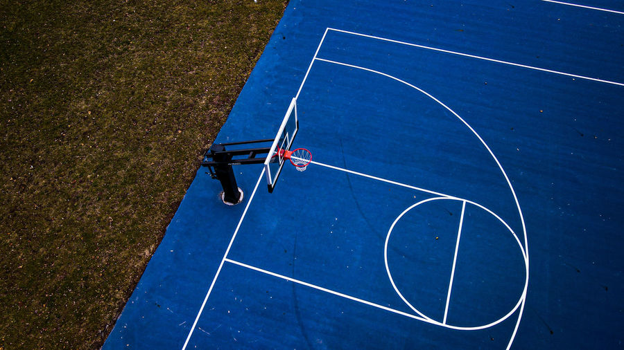 Vibrant blue basketball court at urban menasha park 