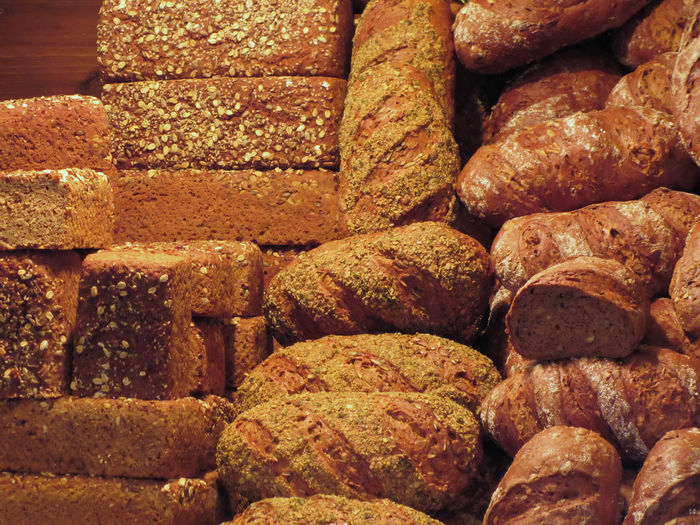 Stacks of fresh breads for sale in bakery