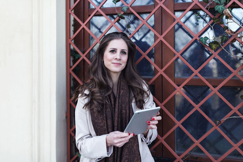 Young woman using digital tablet outdoors. spring or autumn time.