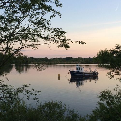 Scenic view of calm lake at sunset