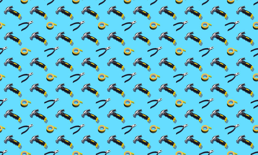 Hammers, pliers, and duct tape on a blue background, pattern