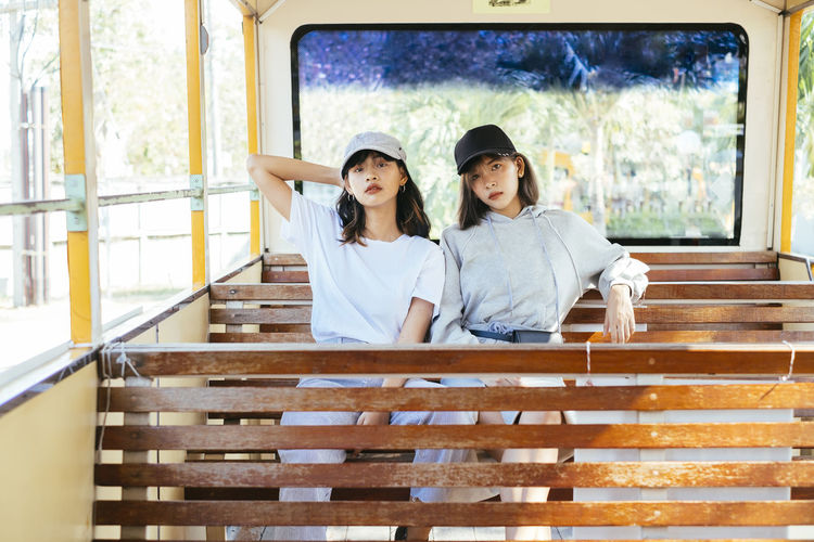 Portrait of friends sitting in toy train