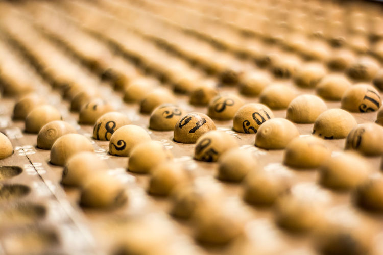 Close-up of wooden lottery balls on tray