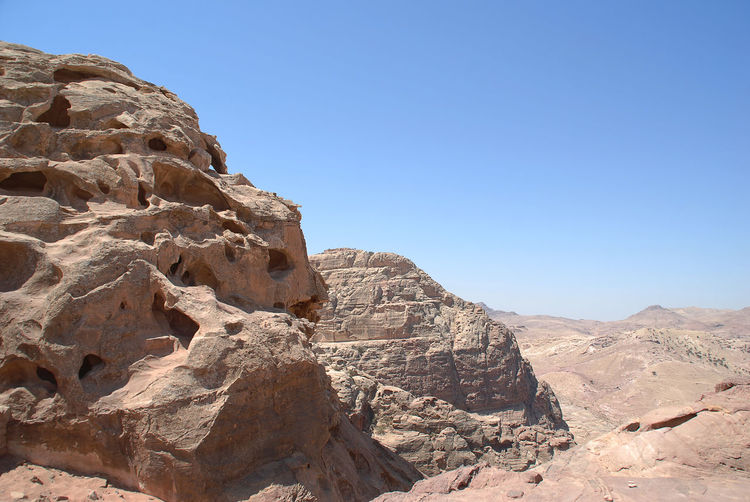 Scenic view of rocky mountains against clear blue sky