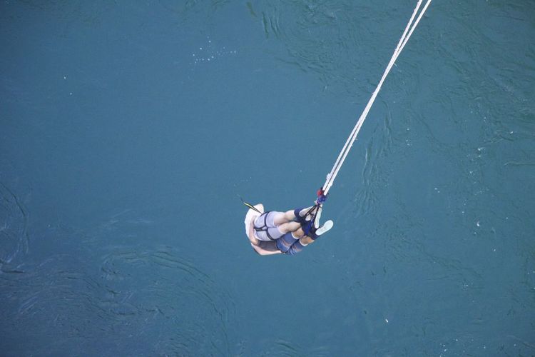 High angle view of people hanging over sea