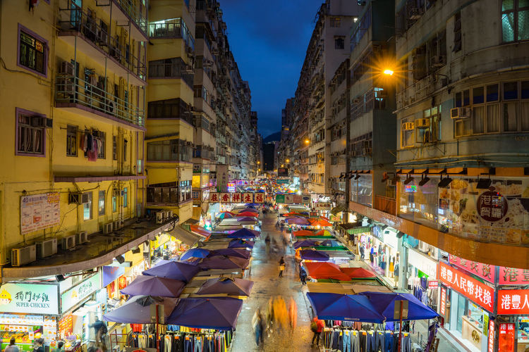 High angle view of illuminated night market amidst buildings in city