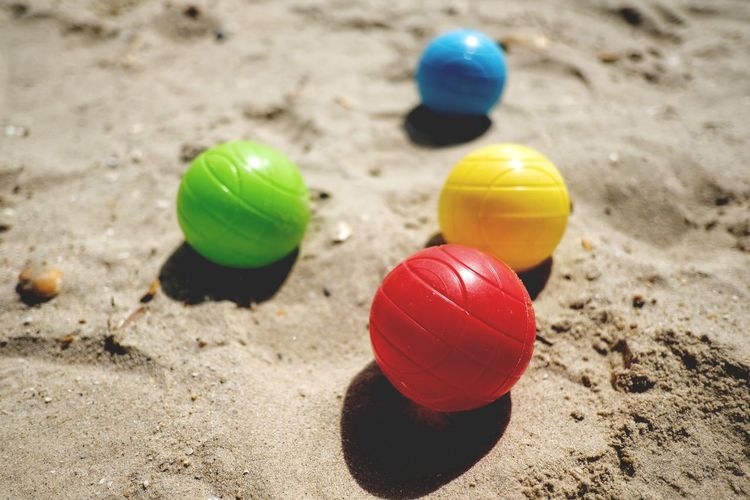 Close-up of multi colored ball on sand