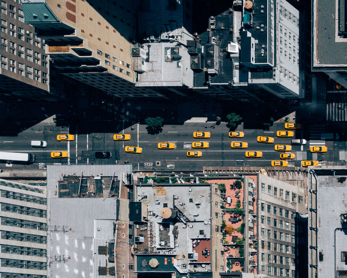Directly above view of cars on street amidst buildings in manhattan