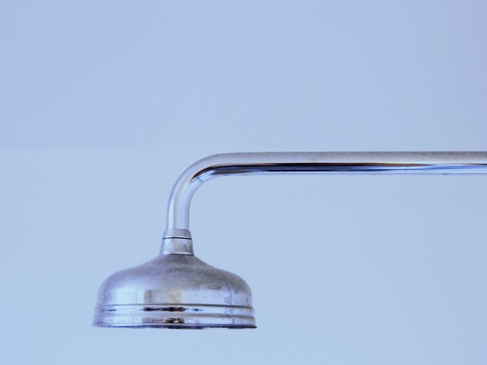 Close-up of shower head against white background