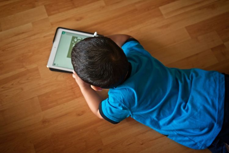 High angle view of man lying on floor at home