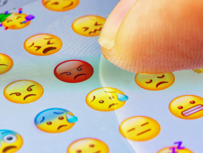 Close-up of finger touching emoticon