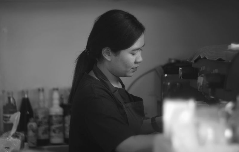 Close-up of woman working at kitchen