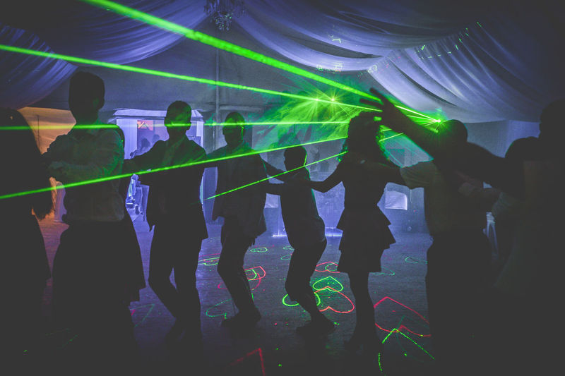 Group of people dancing in nightclub during party
