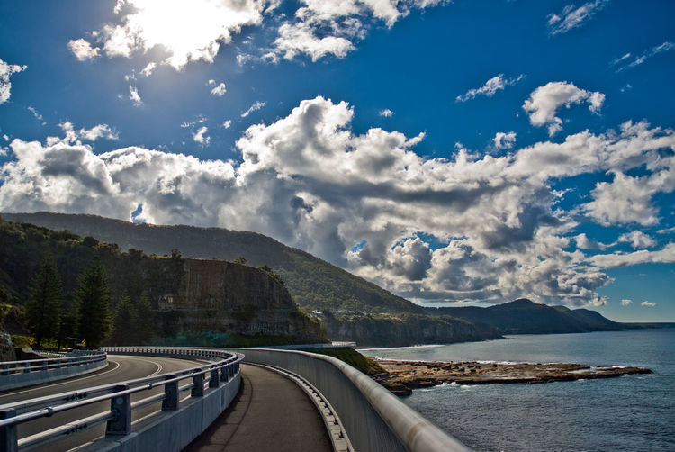 Panoramic view of road by sea against sky