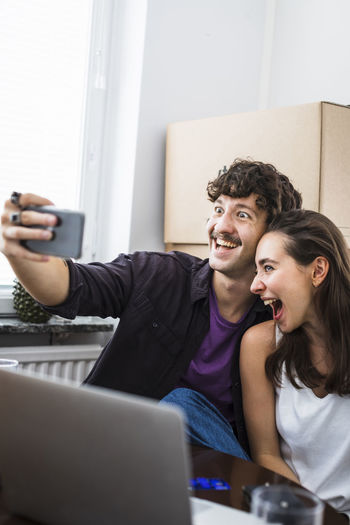 Couple making faces and taking selfie