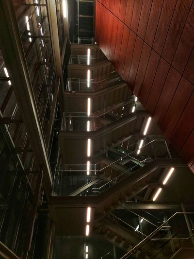 High angle view of illuminated escalator in building