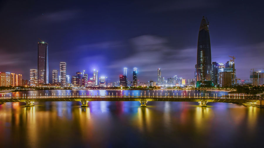 Illuminated modern buildings in city at night