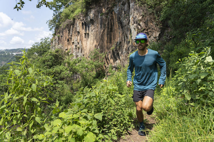 One young man running on a trail in the mountains of zacatlan, puebla