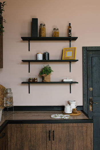 The kitchen is in the scandinavian style. wooden shelves with decor