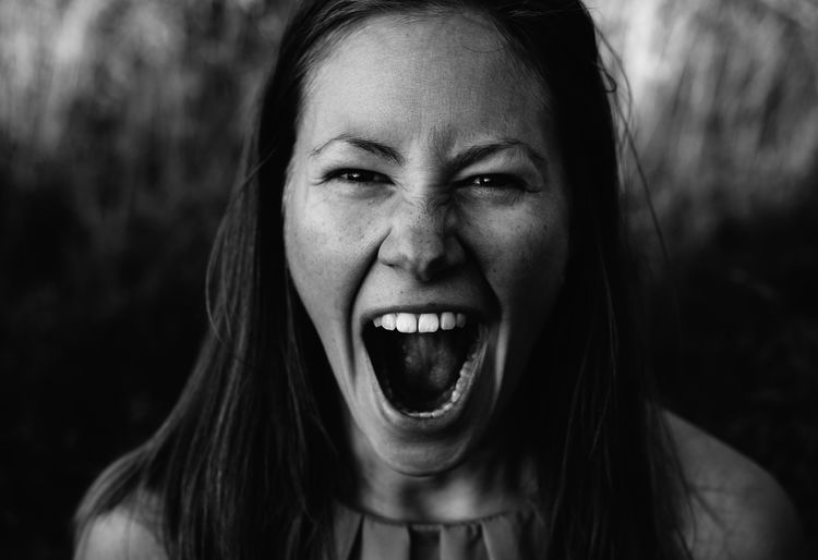 Portrait of young woman screaming