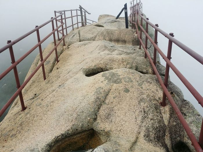High angle view of railing on rock