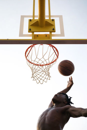 Black man playing basketball game