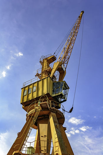 Old yellow crane with blue sky