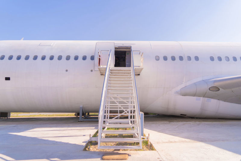 Abandoned airplane at airport against sky