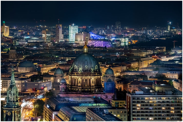 High angle view of city lit up at night
