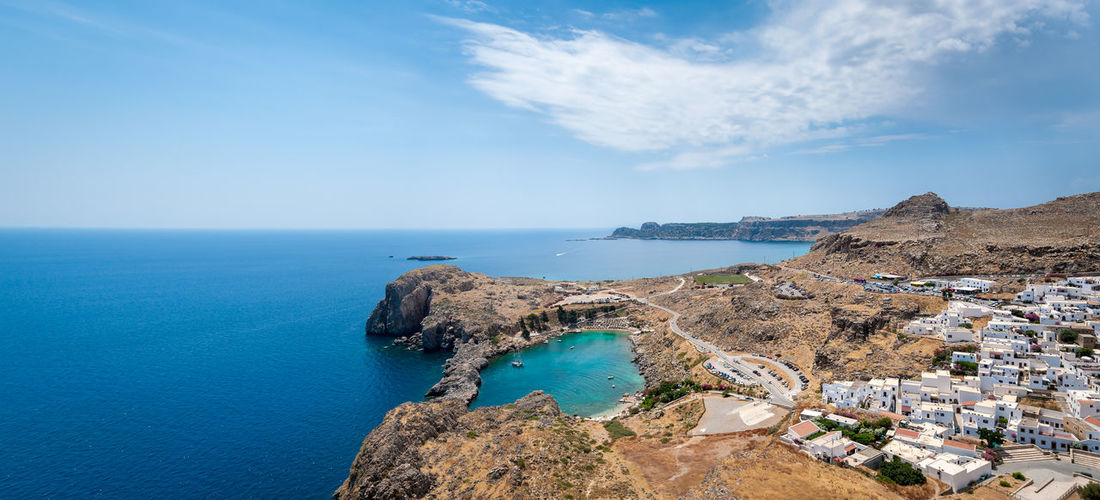 Panoramic view over lindos whitewashed town and enclosed saint paul's bay. island of rhodes. greece.