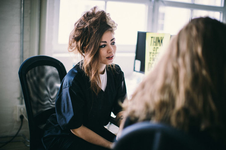Young woman sitting with text