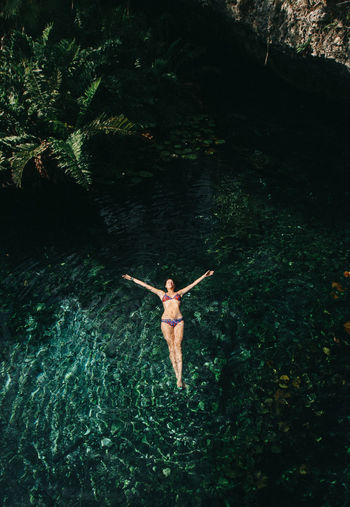 High angle view of woman floating on water