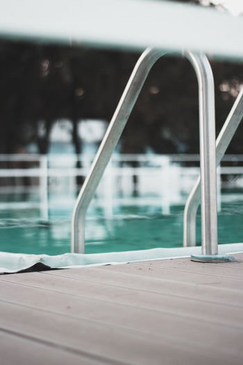 Close-up of railing by swimming pool