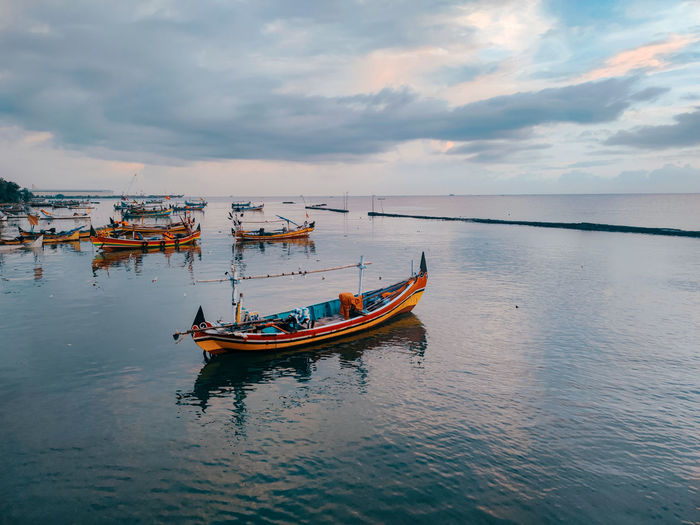 Boats in sea against sky