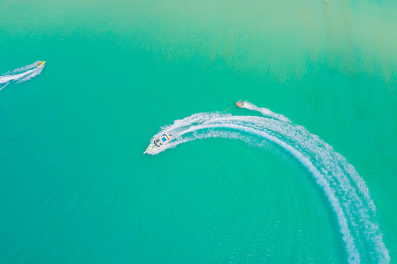 Aerial drone photo of extreme powerboat donut water-sports cruising in tropical thailand, phuket