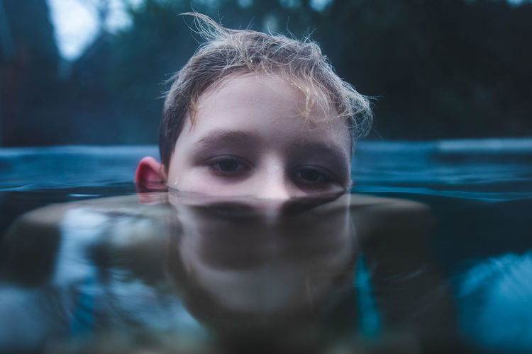 Close-up portrait of a girl swimming in pool