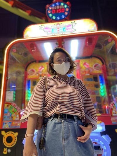 Portrait of woman standing in amusement park