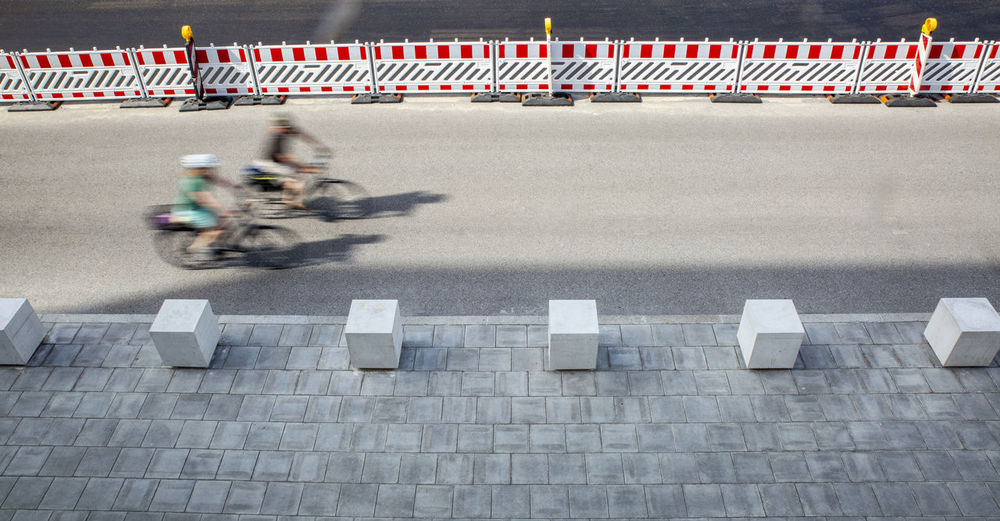 Germany, bavaria, munich, two cyclists in motion