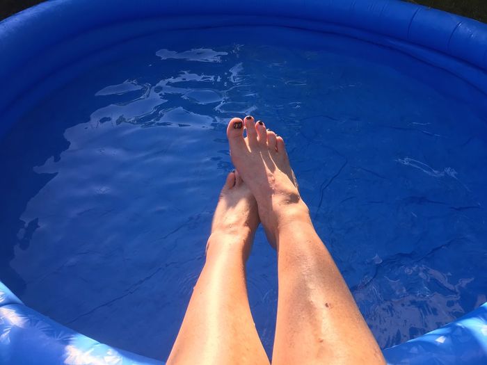 Low section of woman over wading pool