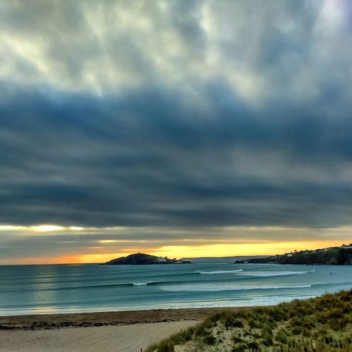 Scenic view of beach against sky during sunset