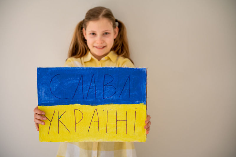 Portrait of girl holding ukrainian flag