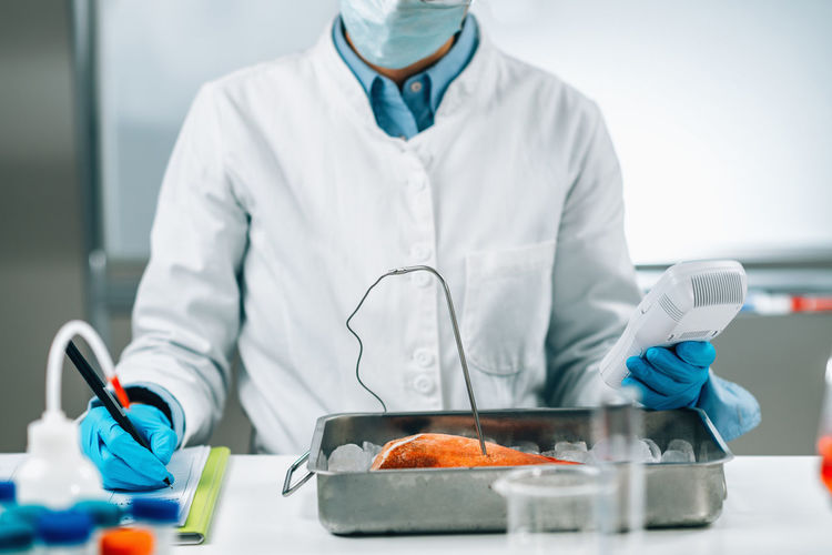 Food safety inspector measuring concentrations of lead, mercury and cadmium in sea fish 