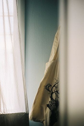 Close-up of clothes drying on window at home