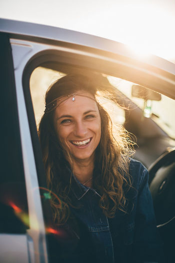 Portrait of smiling young woman in car